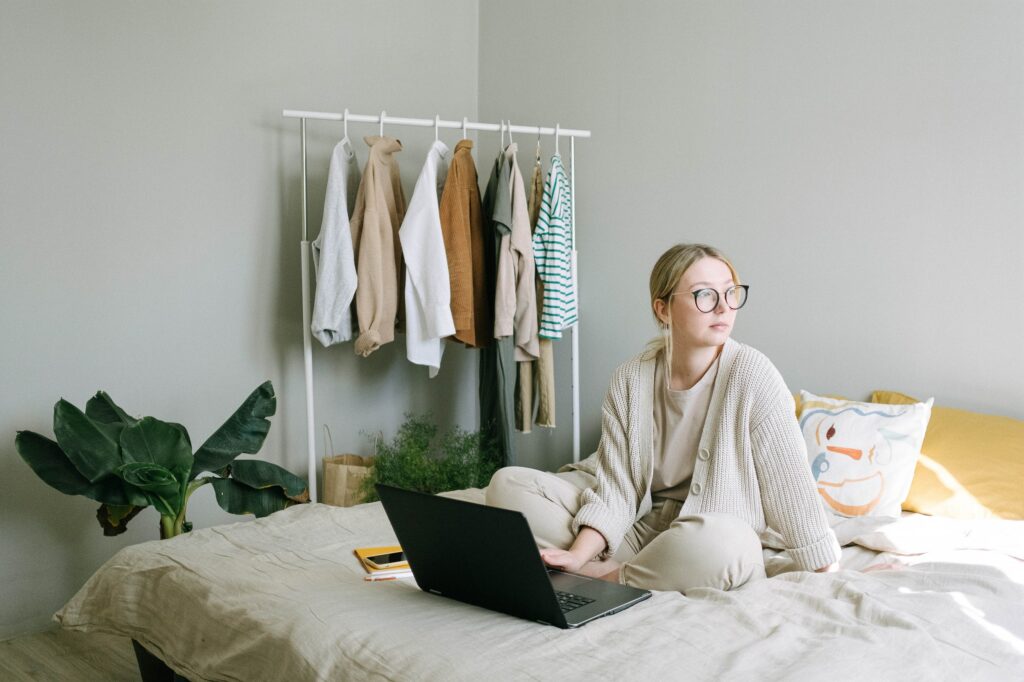You will have an easier time focusing by setting up a real workspace in your bedroom instead of sitting on your bed